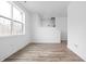 Bright living room with wood flooring and large window, offering natural light and a spacious feel at 443 Flora Pl, Carmel, IN 46290