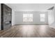 Bright living room with wood floors, a fireplace, and natural light from the windows at 443 Flora Pl, Carmel, IN 46290