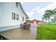 Beautiful backyard featuring patio seating, green lawn, and a barn in the background, perfect for outdoor gatherings at 4491 W 600 N, Anderson, IN 46011