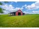 Classic red barn featuring open sides and a rural setting with plenty of grassy land and a blue sky at 4491 W 600 N, Anderson, IN 46011