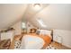 Bright attic bedroom with sloped ceiling and skylight, featuring neutral decor and furnishings at 4491 W 600 N, Anderson, IN 46011