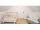 Bedroom area with a crib, cozy chair, and ample natural light, creating a welcoming space at 4491 W 600 N, Anderson, IN 46011