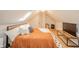 Bright attic bedroom with sloped ceiling and skylight, featuring neutral decor and furnishings at 4491 W 600 N, Anderson, IN 46011