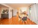 Dining area with hardwood floors, a modern table set, and open access to other rooms at 4491 W 600 N, Anderson, IN 46011
