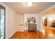 Bright foyer featuring hardwood floors, stairs, and a stylish accent chest with decorative plants at 4491 W 600 N, Anderson, IN 46011