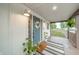 Inviting front porch featuring stylish decor, a textured rug, and a painted blue front door at 4491 W 600 N, Anderson, IN 46011