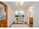 Hallway nook with natural light, built-in beverage center, wood-look vinyl floor, and nearby bathroom at 4491 W 600 N, Anderson, IN 46011