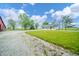 Charming single-story home featuring a covered front porch, gravel driveway, and a lush green lawn at 4491 W 600 N, Anderson, IN 46011