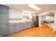 Spacious kitchen featuring butcher block countertops, two-tone cabinets, stainless steel appliances, and hardwood floors at 4491 W 600 N, Anderson, IN 46011