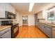 Traditional kitchen with hardwood floors, butcher block countertops, and stainless steel appliances at 4491 W 600 N, Anderson, IN 46011