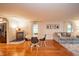 Open-concept living room with a wood stove, hardwood floors, and cozy seating arrangement at 4491 W 600 N, Anderson, IN 46011