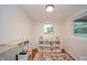 Bright playroom featuring a window, hardwood floors, and play kitchen and shelving at 4491 W 600 N, Anderson, IN 46011