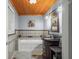 Bathroom with tiled walls, wood plank ceiling, granite countertop vanity, and a modern soaking tub at 460 W Hinshaw Dr, Nineveh, IN 46164