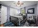 Comfortable bedroom with a dark color scheme, ceiling fan and natural light from the window at 460 W Hinshaw Dr, Nineveh, IN 46164