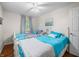 Bright bedroom featuring two beds with blue accents and a ceiling fan at 460 W Hinshaw Dr, Nineveh, IN 46164