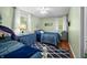 Inviting bedroom with two beds, blue accents, and natural light from a window at 460 W Hinshaw Dr, Nineveh, IN 46164