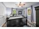 Comfortable bedroom with a dark color scheme, ceiling fan and natural light from the window at 460 W Hinshaw Dr, Nineveh, IN 46164