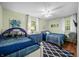 Inviting bedroom with two beds, blue accents, and natural light from a window at 460 W Hinshaw Dr, Nineveh, IN 46164