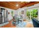 The dining area features wood floors, a wood ceiling, a sliding glass door to the back, and stainless refrigerator at 460 W Hinshaw Dr, Nineveh, IN 46164