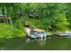 View of the dock on the water with a boat slip, sitting area, and direct access to the home at 460 W Hinshaw Dr, Nineveh, IN 46164