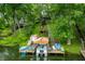 View of the dock on the water with a boat slip, sitting area, and direct access to the home at 460 W Hinshaw Dr, Nineveh, IN 46164