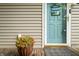 Inviting front door with a 'Welcome to our House' sign, a potted plant, and a gray doormat at 460 W Hinshaw Dr, Nineveh, IN 46164