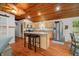 The kitchen features stainless steel appliances, maple cabinets, an island with a bar, and a vaulted, wood ceiling at 460 W Hinshaw Dr, Nineveh, IN 46164