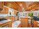 Cozy kitchen with stainless steel appliances, wood cabinets, hardwood floors, and an island with seating at 460 W Hinshaw Dr, Nineveh, IN 46164