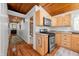 The kitchen features stainless steel appliances, including a range and microwave, complemented by wooden cabinets at 460 W Hinshaw Dr, Nineveh, IN 46164