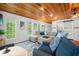 Cozy living room boasts a wood ceiling, neutral sectional, modern decor, and an abundance of natural light at 460 W Hinshaw Dr, Nineveh, IN 46164