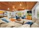 Inviting living room featuring comfortable sectional seating, wood ceiling, and a seamless transition to the dining area at 460 W Hinshaw Dr, Nineveh, IN 46164