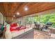 Covered outdoor patio with wood plank ceiling, outdoor seating, and stairs to the backyard at 460 W Hinshaw Dr, Nineveh, IN 46164