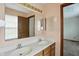 Bathroom featuring double sink vanity, mirror and a view into an adjacent room at 4749 Rocky Knob Ln, Indianapolis, IN 46254