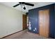 Bedroom with carpet, ceiling fan and painted accent wall with closet doors at 4749 Rocky Knob Ln, Indianapolis, IN 46254