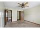 Modest bedroom with neutral walls, carpet and a view into an adjacent room at 4749 Rocky Knob Ln, Indianapolis, IN 46254