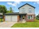 Charming two-story home with a two-car garage and well-manicured lawn at 4749 Rocky Knob Ln, Indianapolis, IN 46254