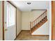 Welcoming foyer with tile flooring, wooden staircase, and neutral paint at 4749 Rocky Knob Ln, Indianapolis, IN 46254