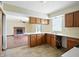 Open kitchen overlooking living room featuring laminate countertops and wood cabinets at 4749 Rocky Knob Ln, Indianapolis, IN 46254