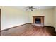 Living room featuring wood floors, ceiling fan, and brick fireplace with mantle at 4749 Rocky Knob Ln, Indianapolis, IN 46254