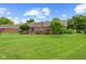 Expansive backyard featuring solar panels, a deck, and lush green lawn at 476 Turnberry Ct, Avon, IN 46123