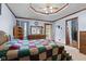 Bedroom with a large bed, a dresser with a mirror, and a ceiling fan with a view of the outdoor deck at 476 Turnberry Ct, Avon, IN 46123