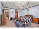 Bedroom featuring a bed with colorful quilt, a ceiling fan, and a wooden dresser on carpeted floors at 476 Turnberry Ct, Avon, IN 46123