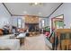 Cozy living room features a brick fireplace, plush carpeting, and comfortable seating at 476 Turnberry Ct, Avon, IN 46123