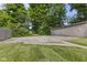 Backyard featuring green grass and a detached garage with a parking area at 4836 Winthrop Ave, Indianapolis, IN 46205