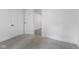 Empty bedroom showcasing neutral carpet and entry to another room at 4836 Winthrop Ave, Indianapolis, IN 46205