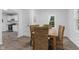 Dining room with wood table and six wicker chairs, view to kitchen and light from the window at 4836 Winthrop Ave, Indianapolis, IN 46205