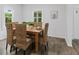 Bright dining room features a wooden table with seating for six and views of the outdoors at 4836 Winthrop Ave, Indianapolis, IN 46205