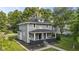 Charming two-story home with a covered front porch and well-maintained landscaping. Trees provide shade at 4836 Winthrop Ave, Indianapolis, IN 46205