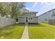 Charming gray home with a neatly kept lawn, a walkway, and a fenced yard at 4836 Winthrop Ave, Indianapolis, IN 46205