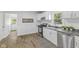 Bright kitchen featuring white cabinets, modern appliances, and hardwood floors, offering both style and functionality at 4836 Winthrop Ave, Indianapolis, IN 46205